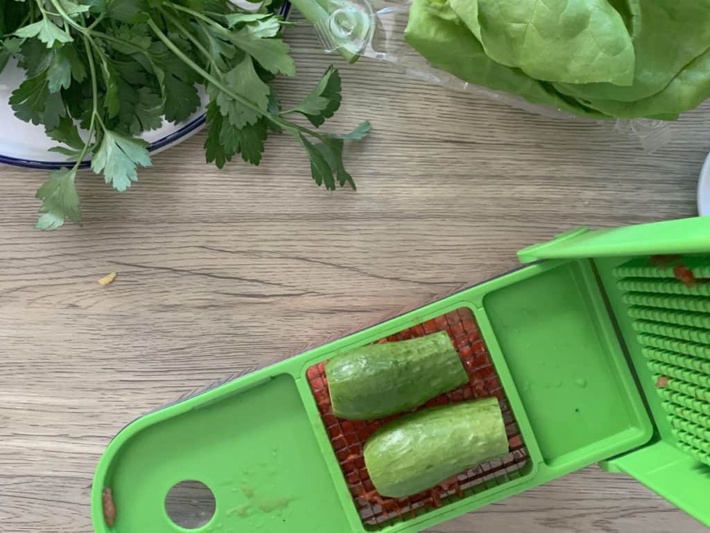Chopping cucumbers for garnish.