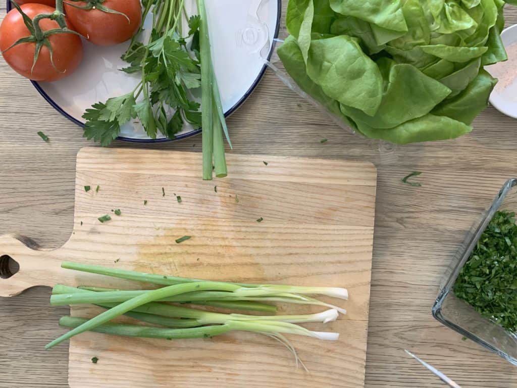 Chopping scallions for garnish.