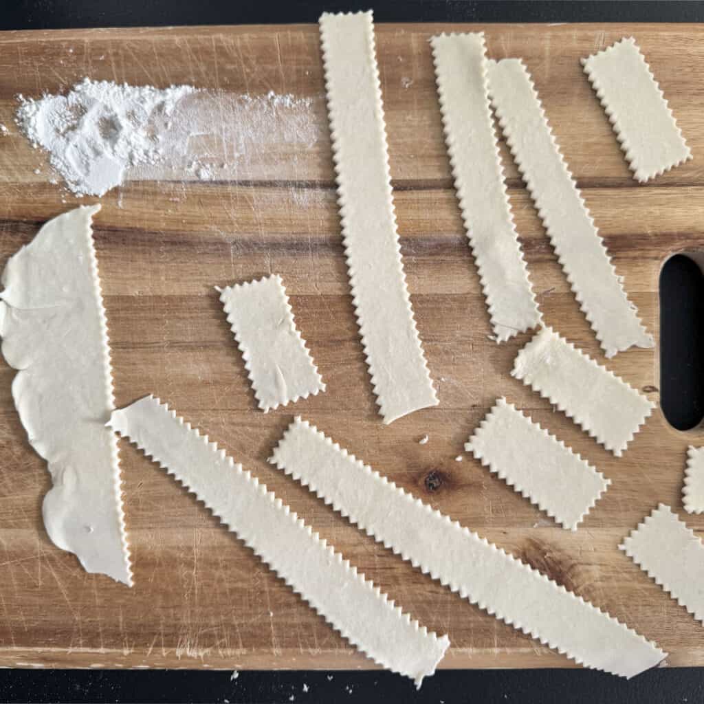 Gnocco fritto strips on a wooden board.