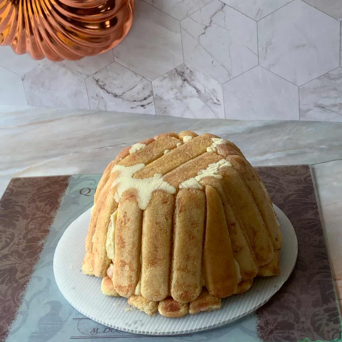 Cake is inverted on a cake board.