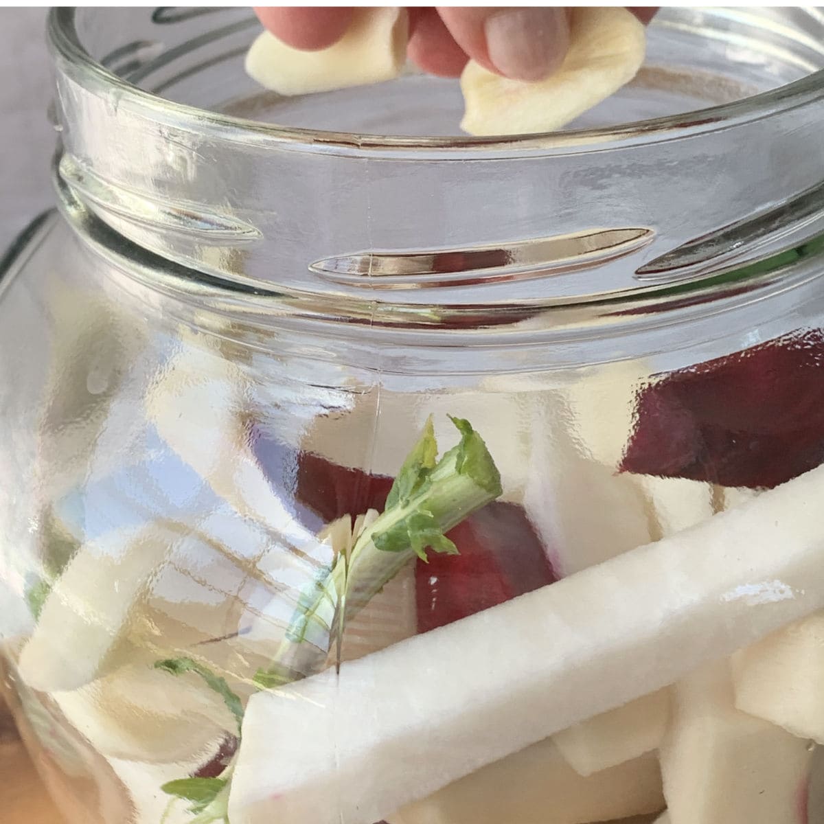 Adding garlic to the vegetable mix