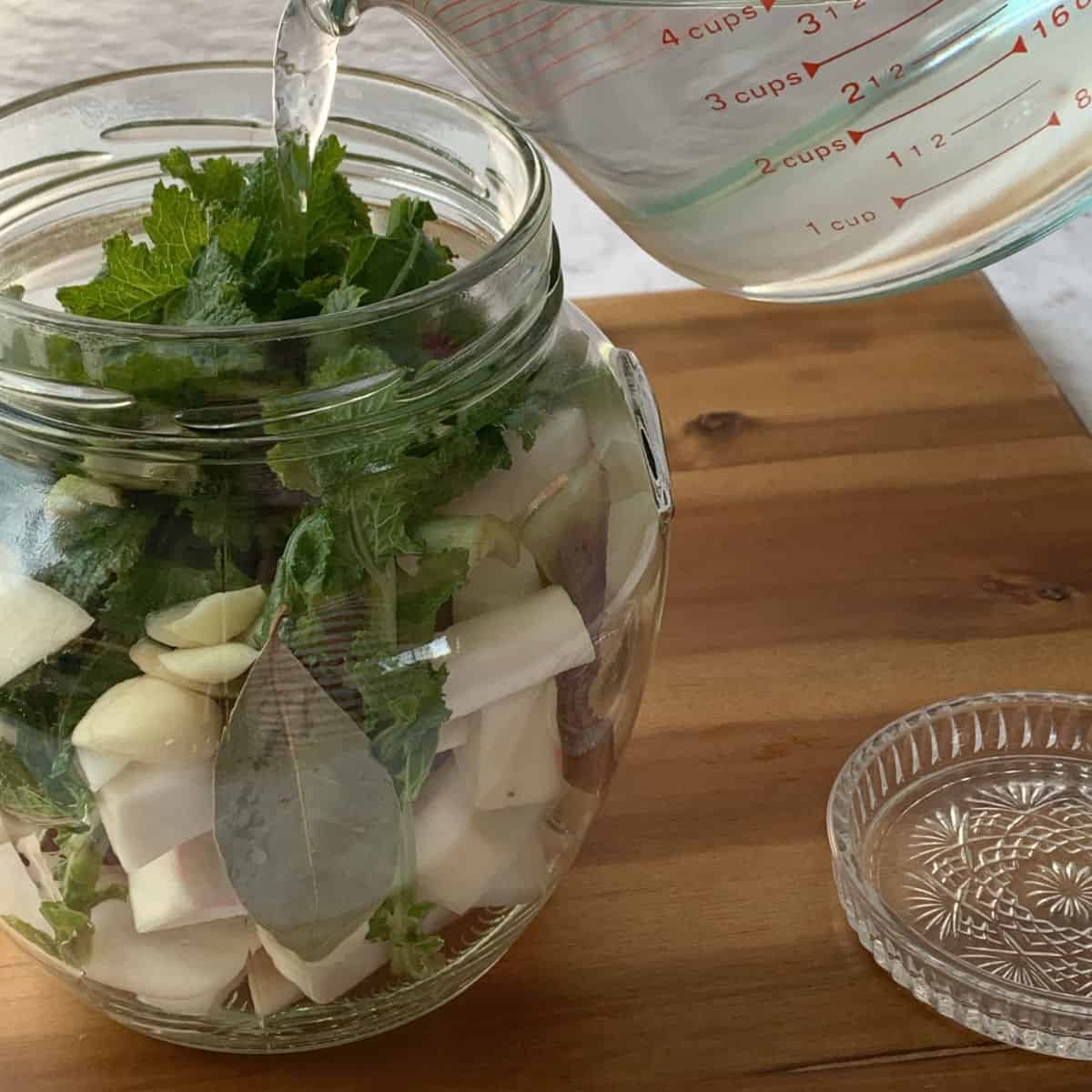 Pouring the brine over the turnips.