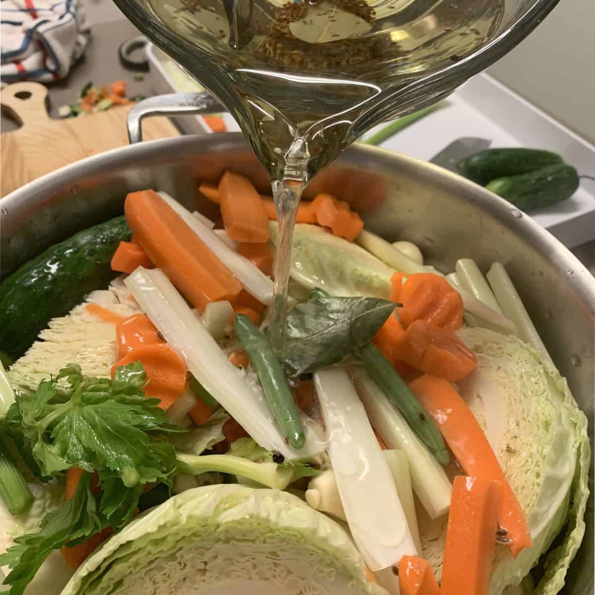 Pouring the brine over the vegetables.