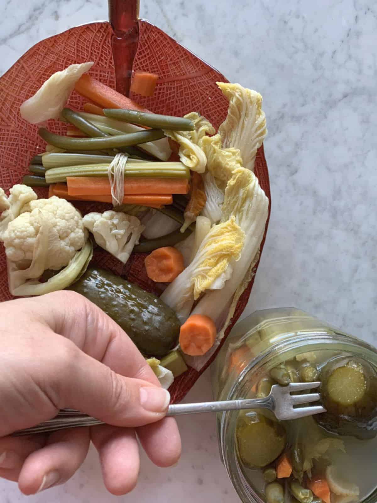 Pickled cucumber on a fork.