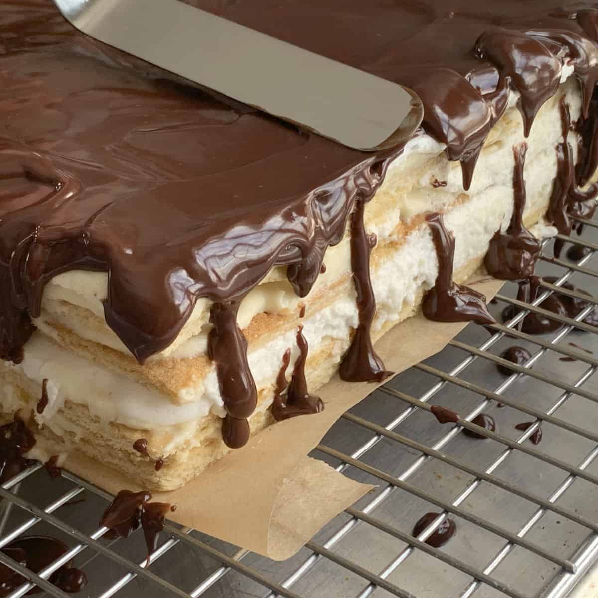 Assembling the cake by adding the glaze.