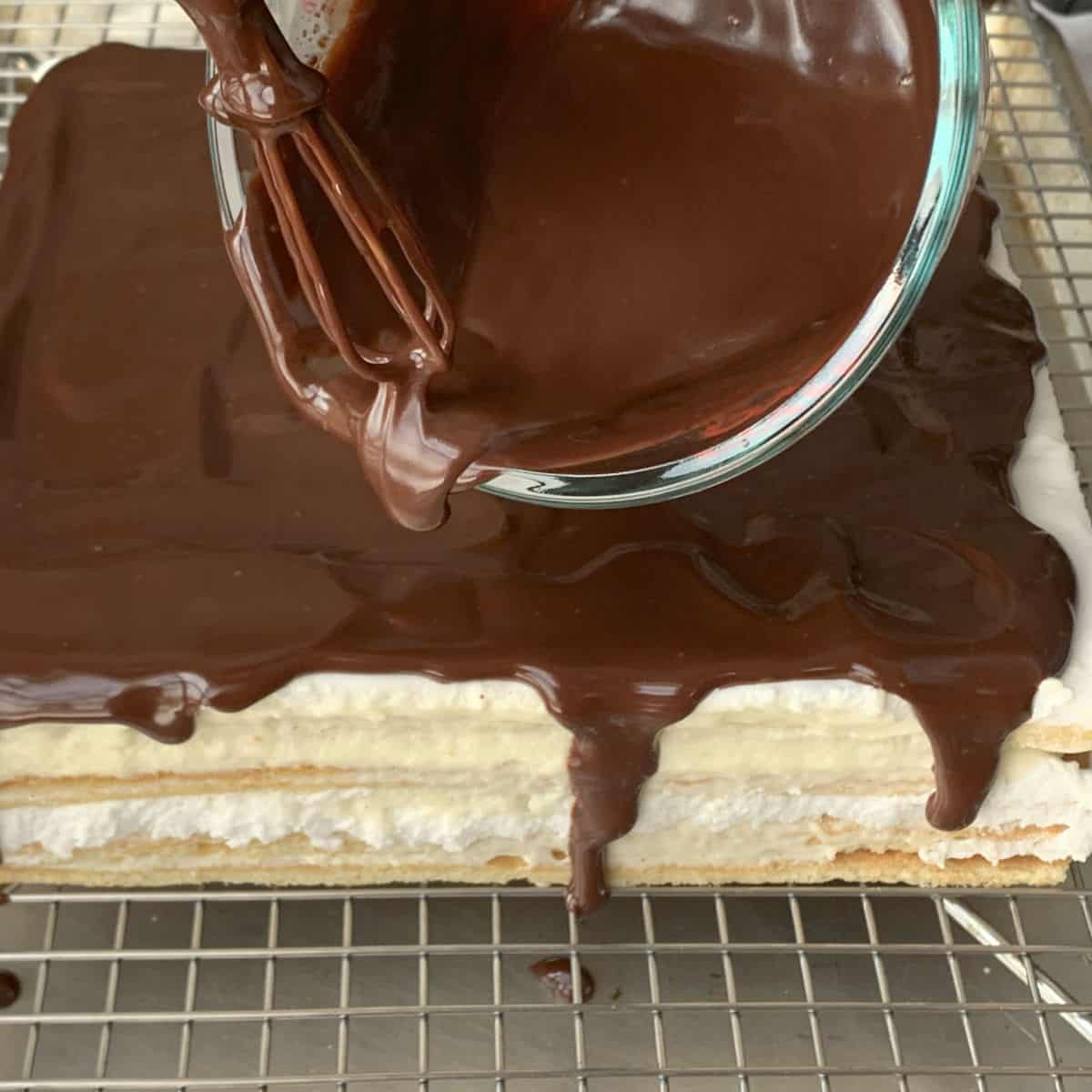 Assembling the cake by adding the glaze.