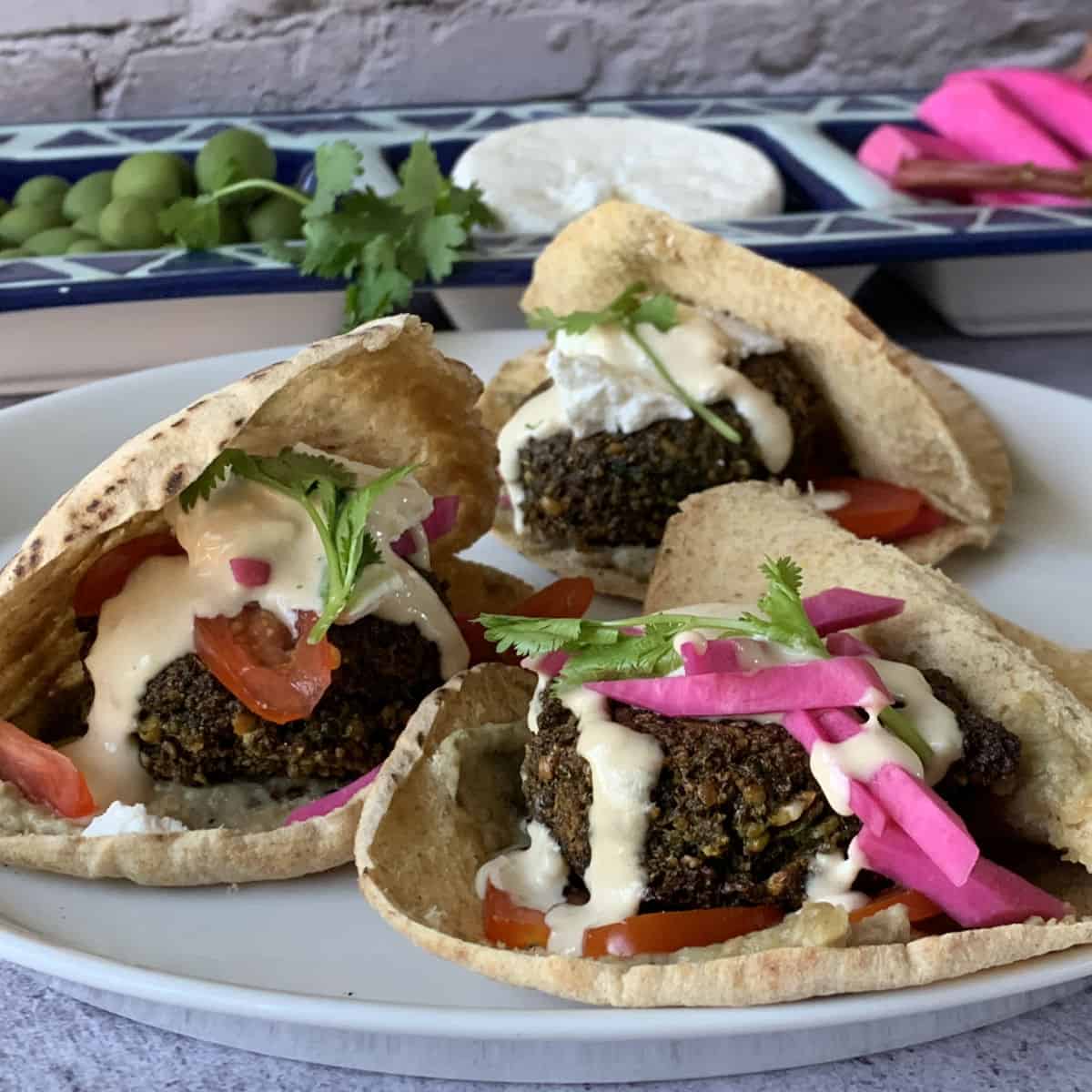 Assembled Falafel patties on a pita bread.