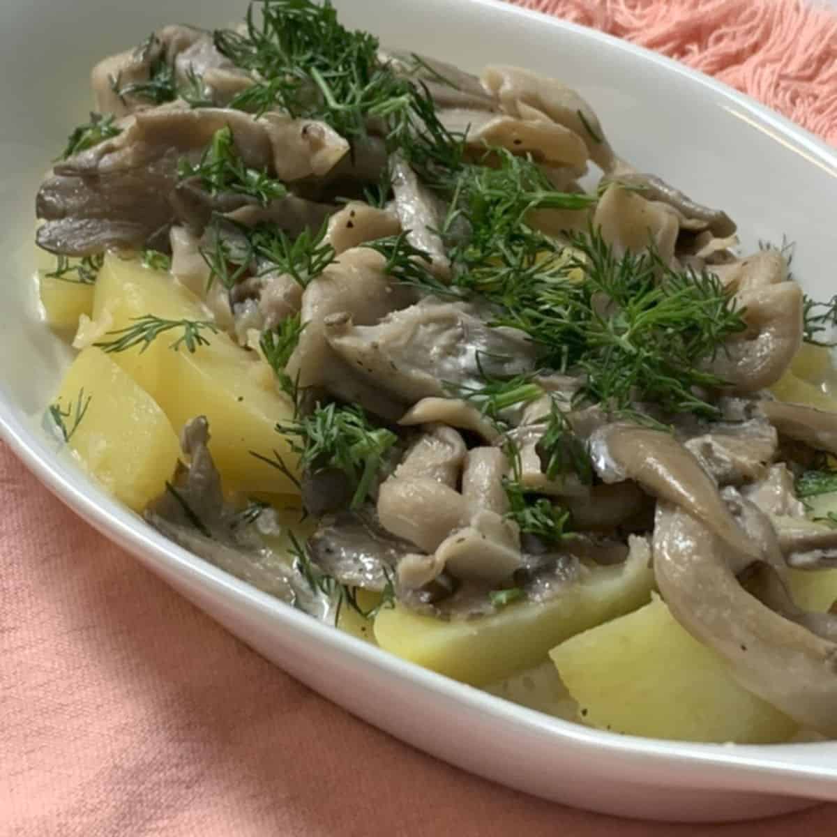 Oyster mushrooms and potatoes in a gratin dish.