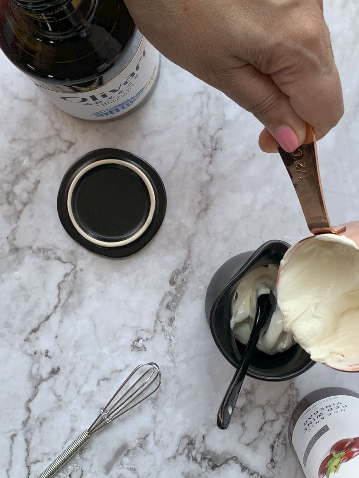 Adding a cup of cream into a jar.