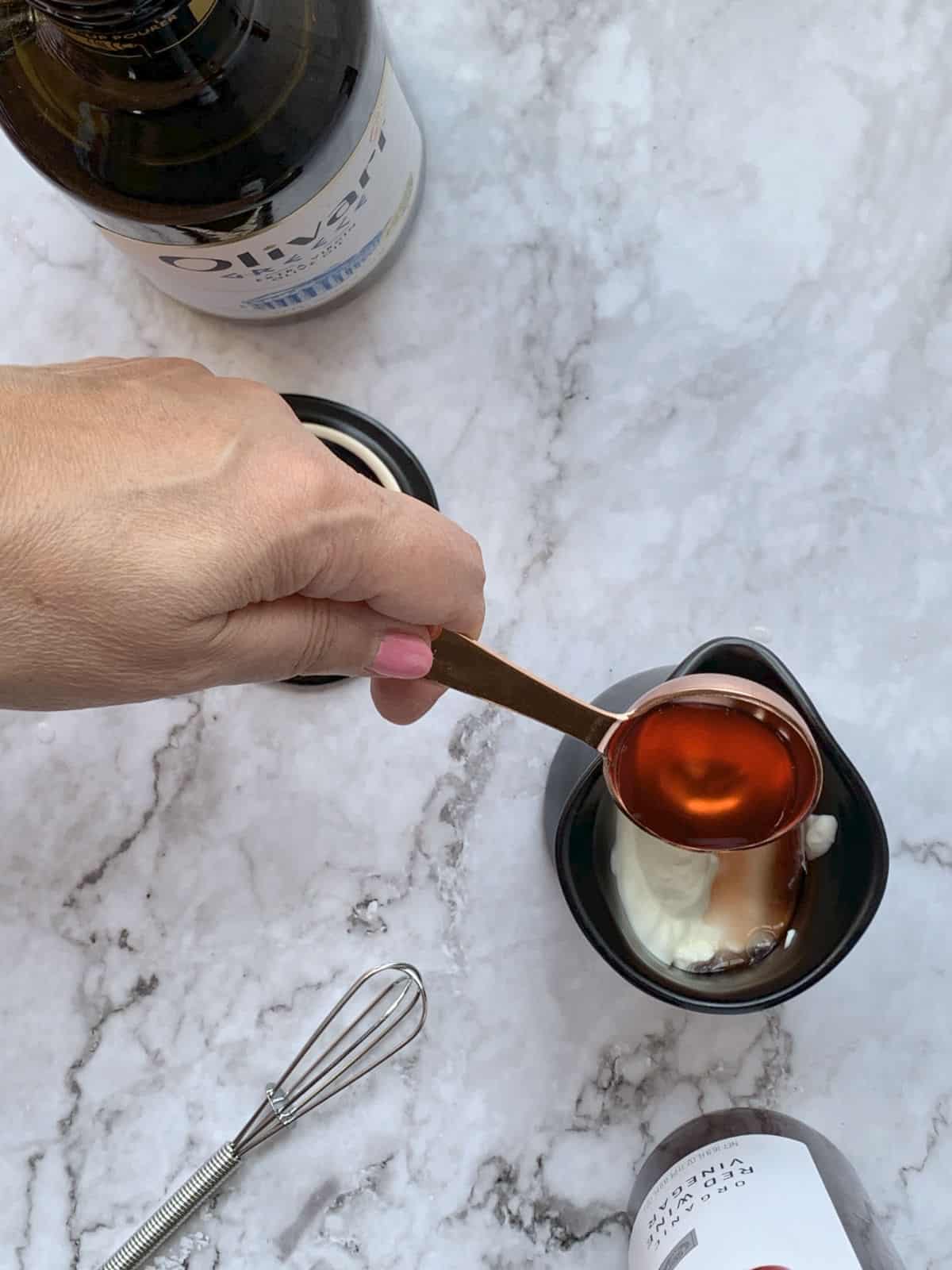 Adding vinegar to the cream.