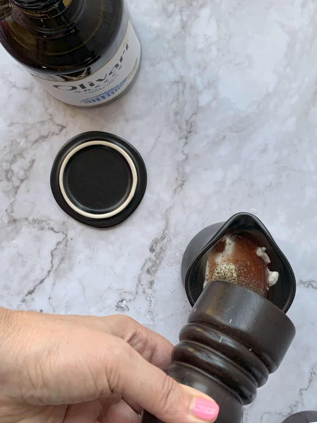 Adding freshly ground black pepper to the sour cream