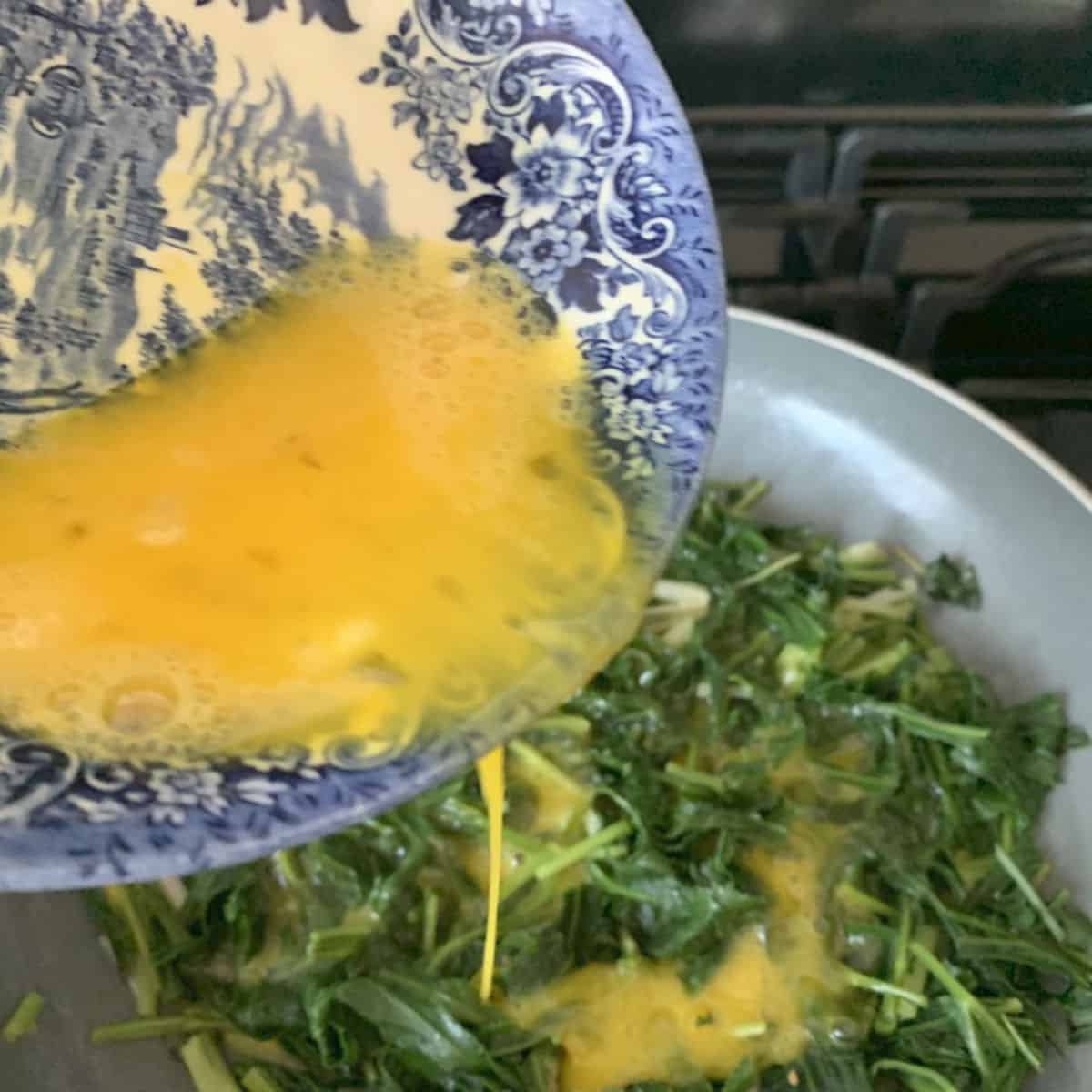 Adding eggs to sibekh.
