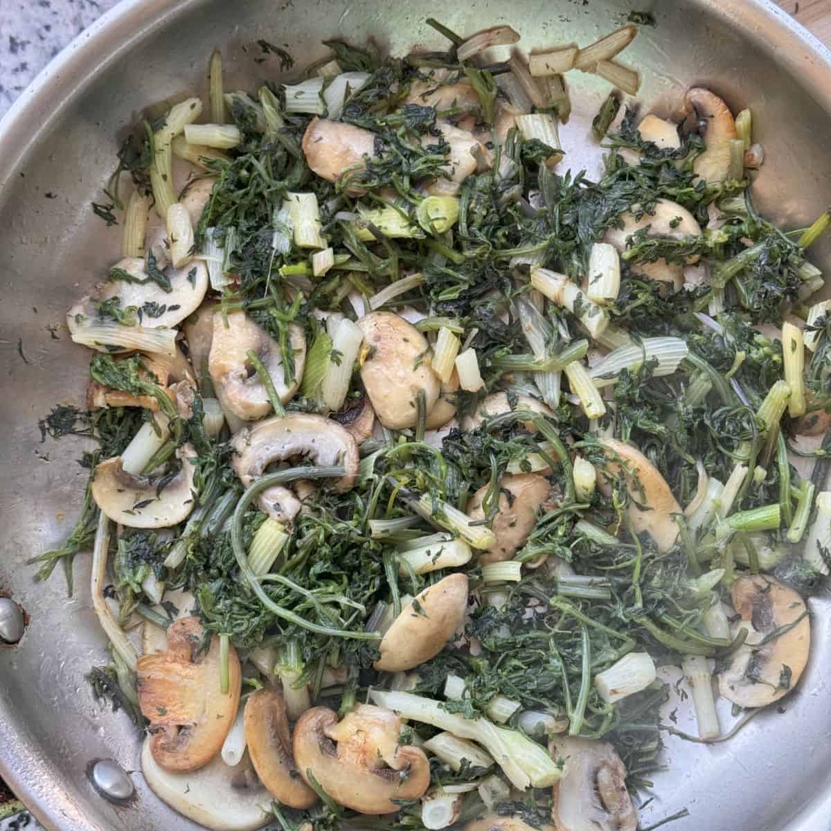A pan of mushrooms and shushan on a counter.