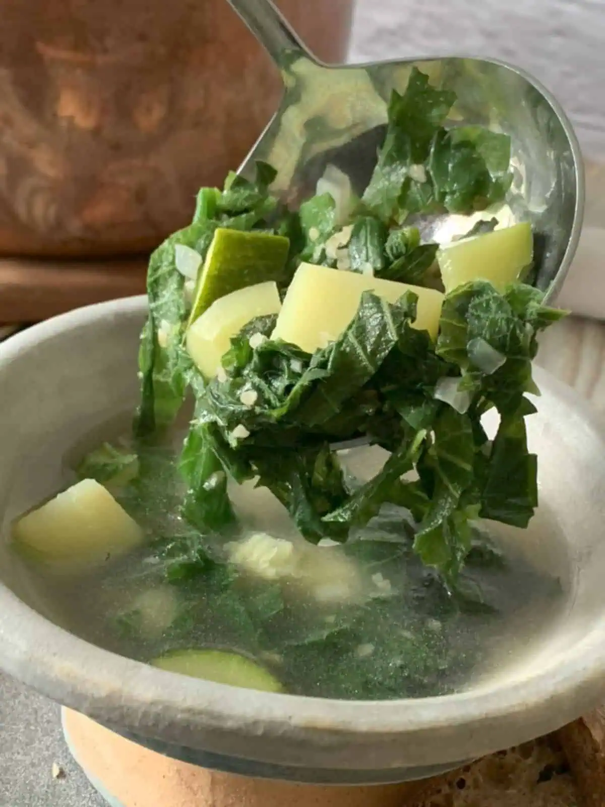 Pouring nettle soup into a bowl.