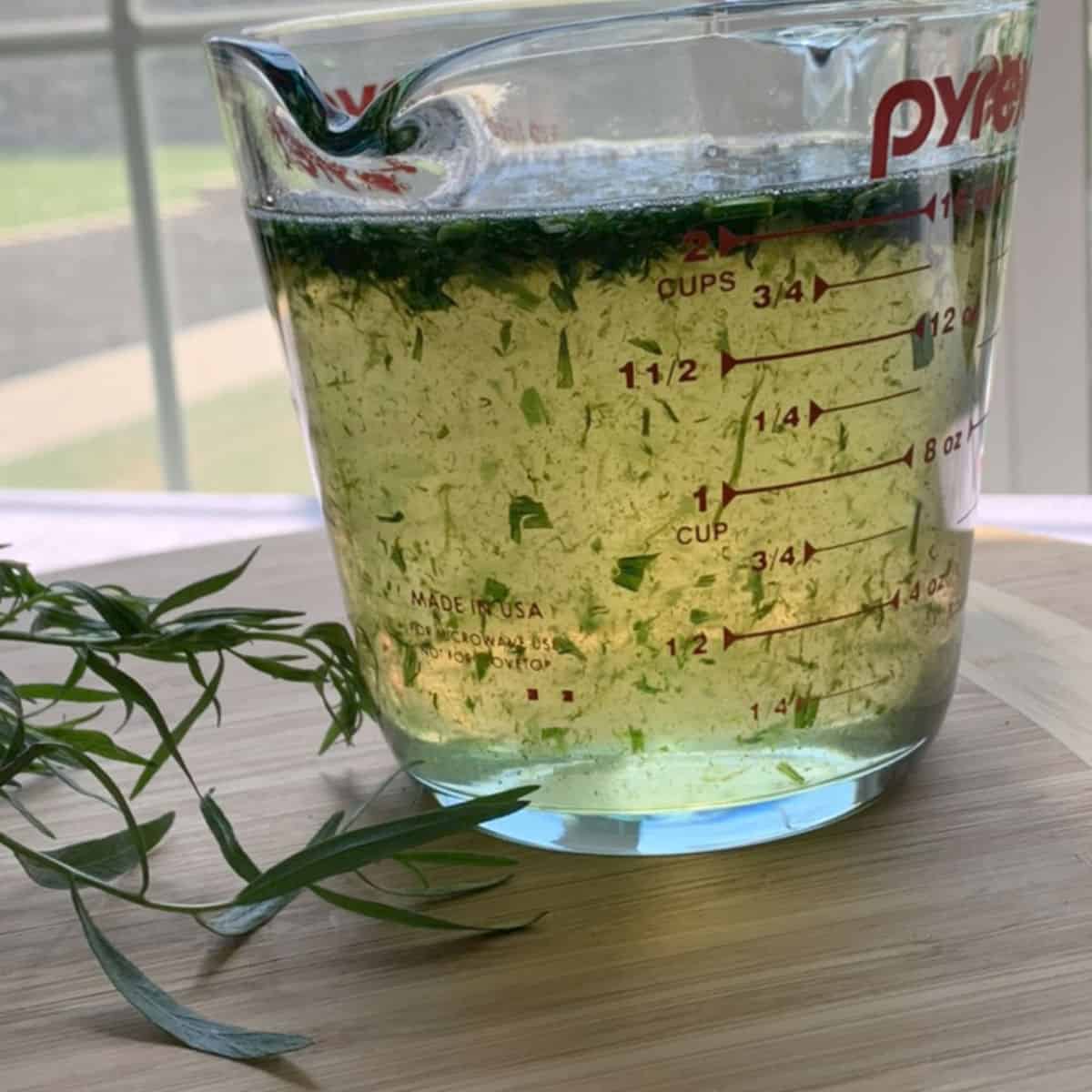 Syrup with chopped tarragon leaves.