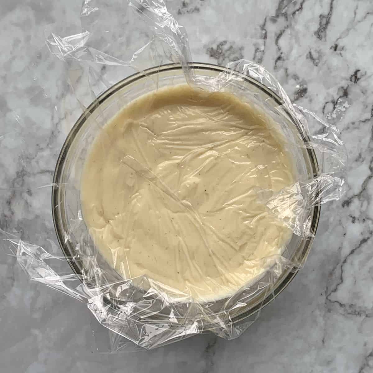 Pastry cream covered with plastic wrap.