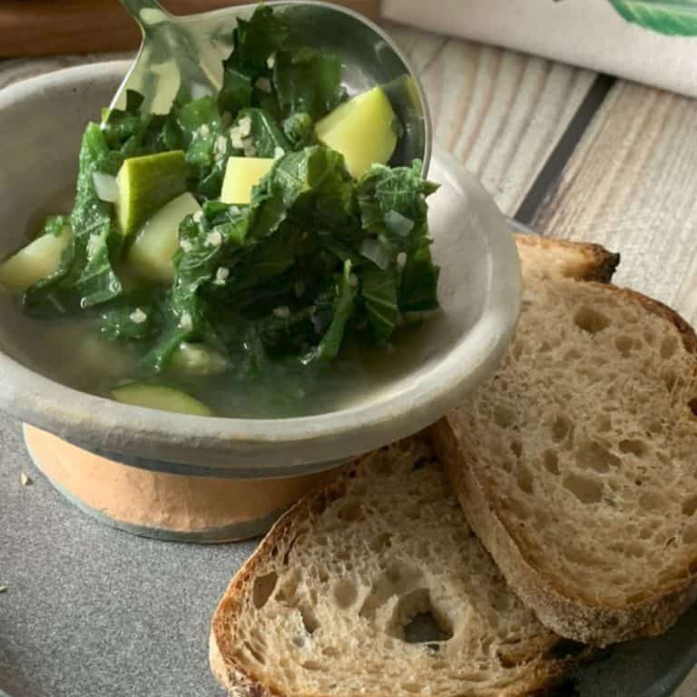 Pouring nettle soup into a bowl.