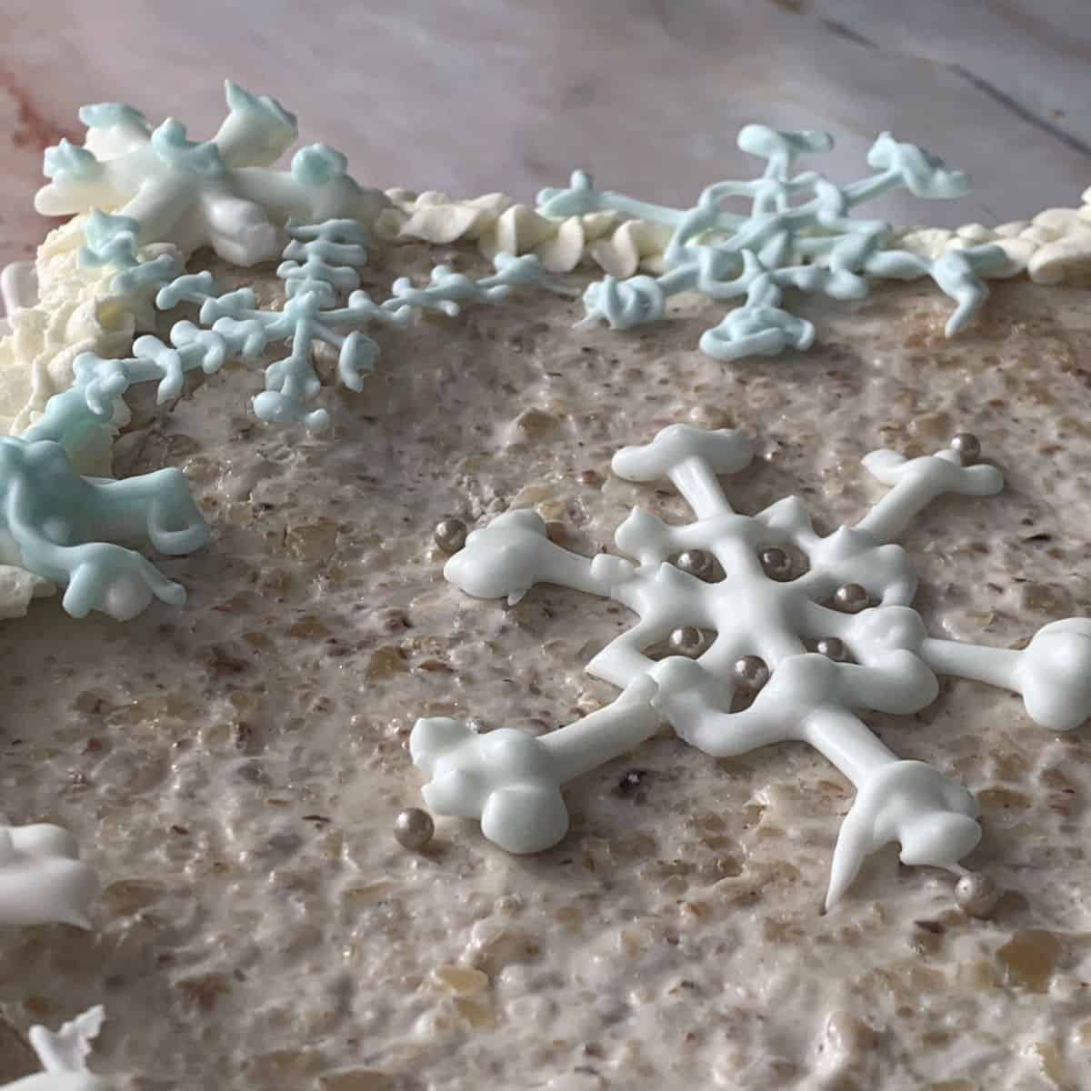 Snowflake decorations on sour cream cake.