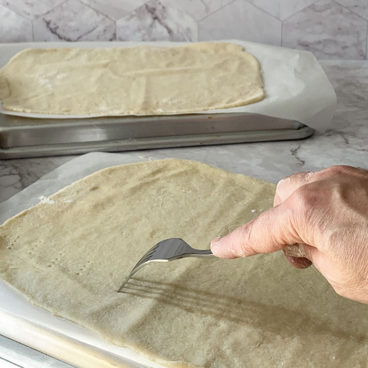 Pricking the cake layers before baking.