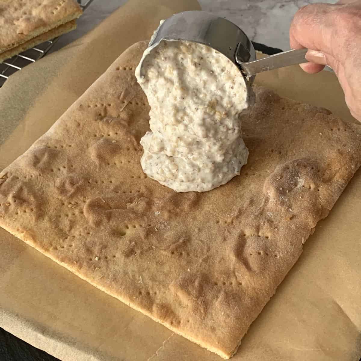 Spreading the walnut sour cream frosting.