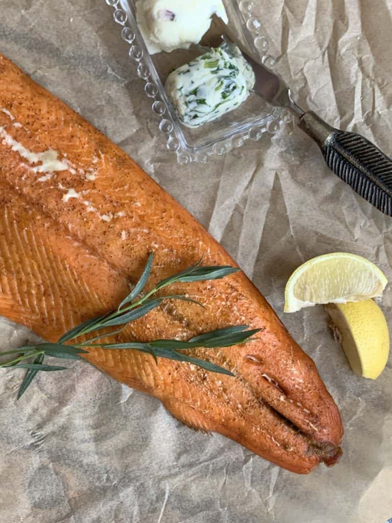 Vertical image of the smoked salmon with lemon and tarragon springs.