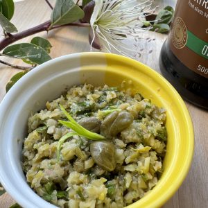 Capers tarragon tapenade in a yellow bowl.