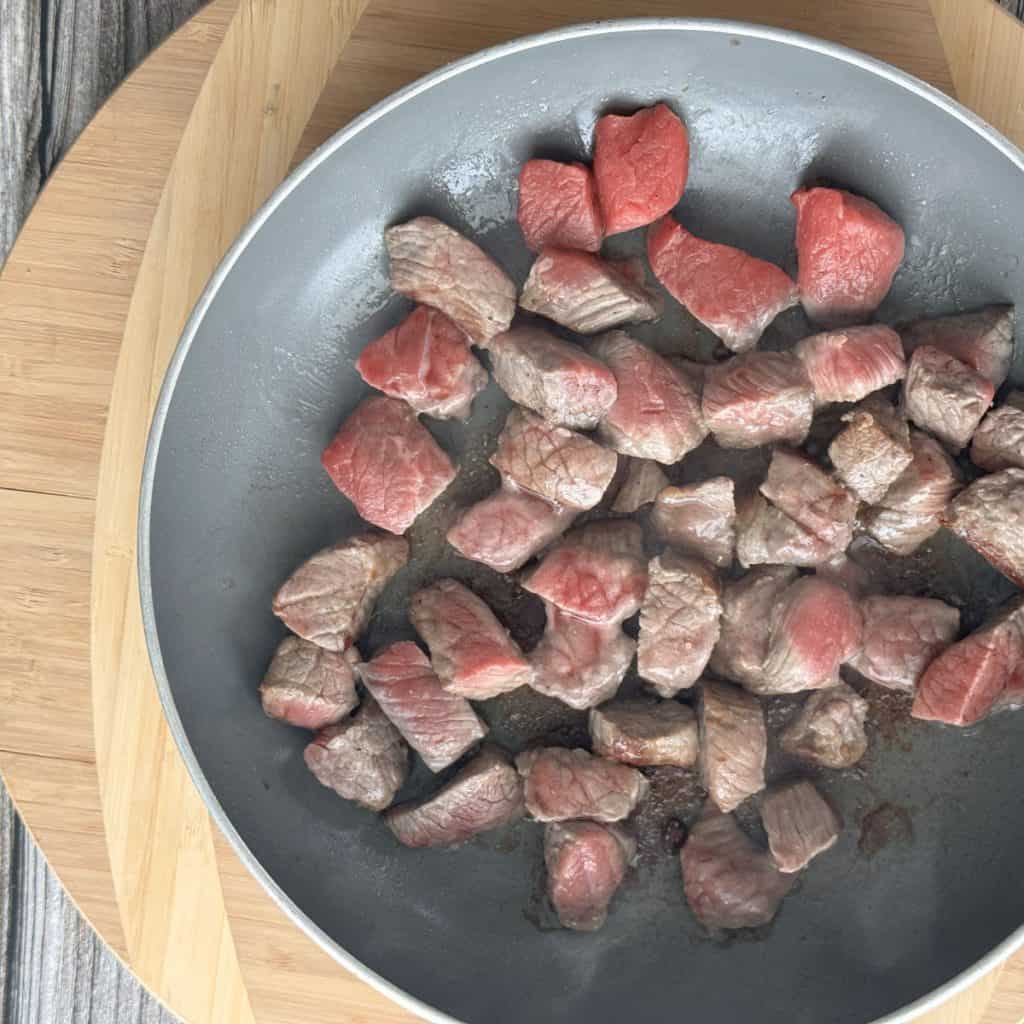 Stew meat in a pan.