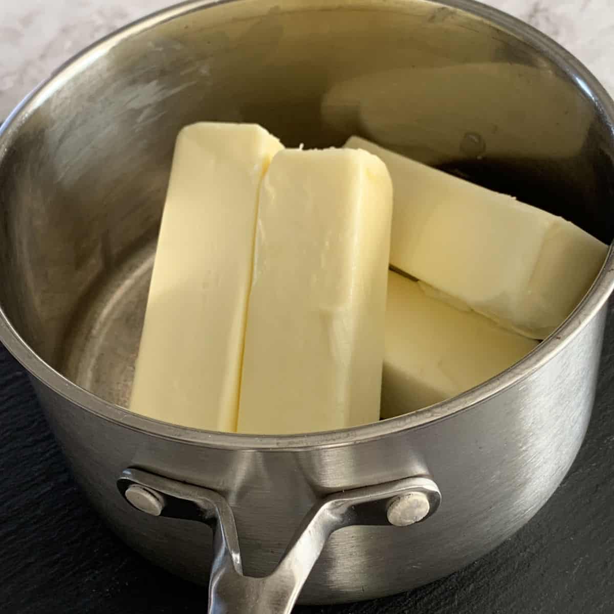 Sticks of butter in a pot.