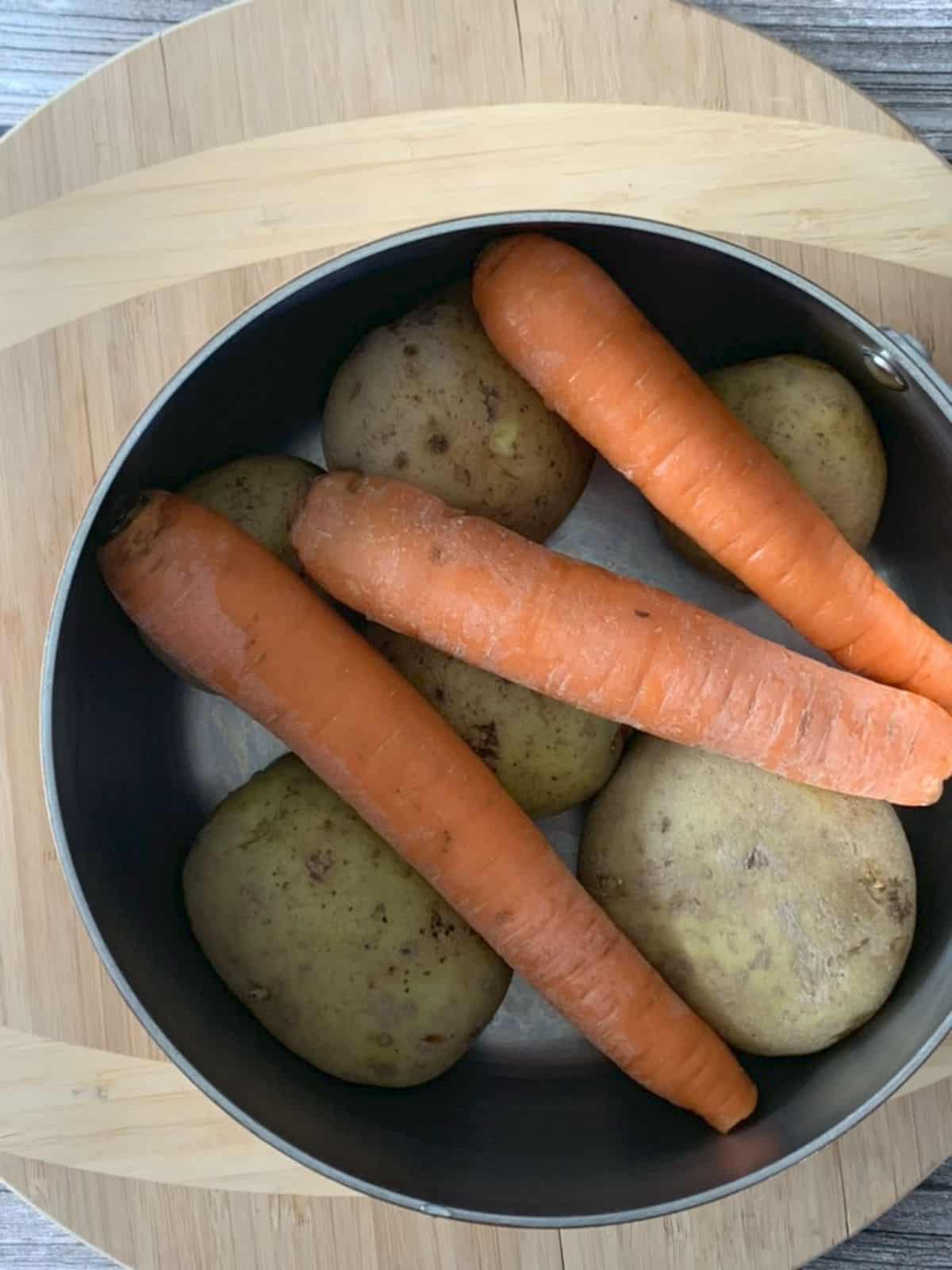 Boiling and peeling potatoes and carrots.