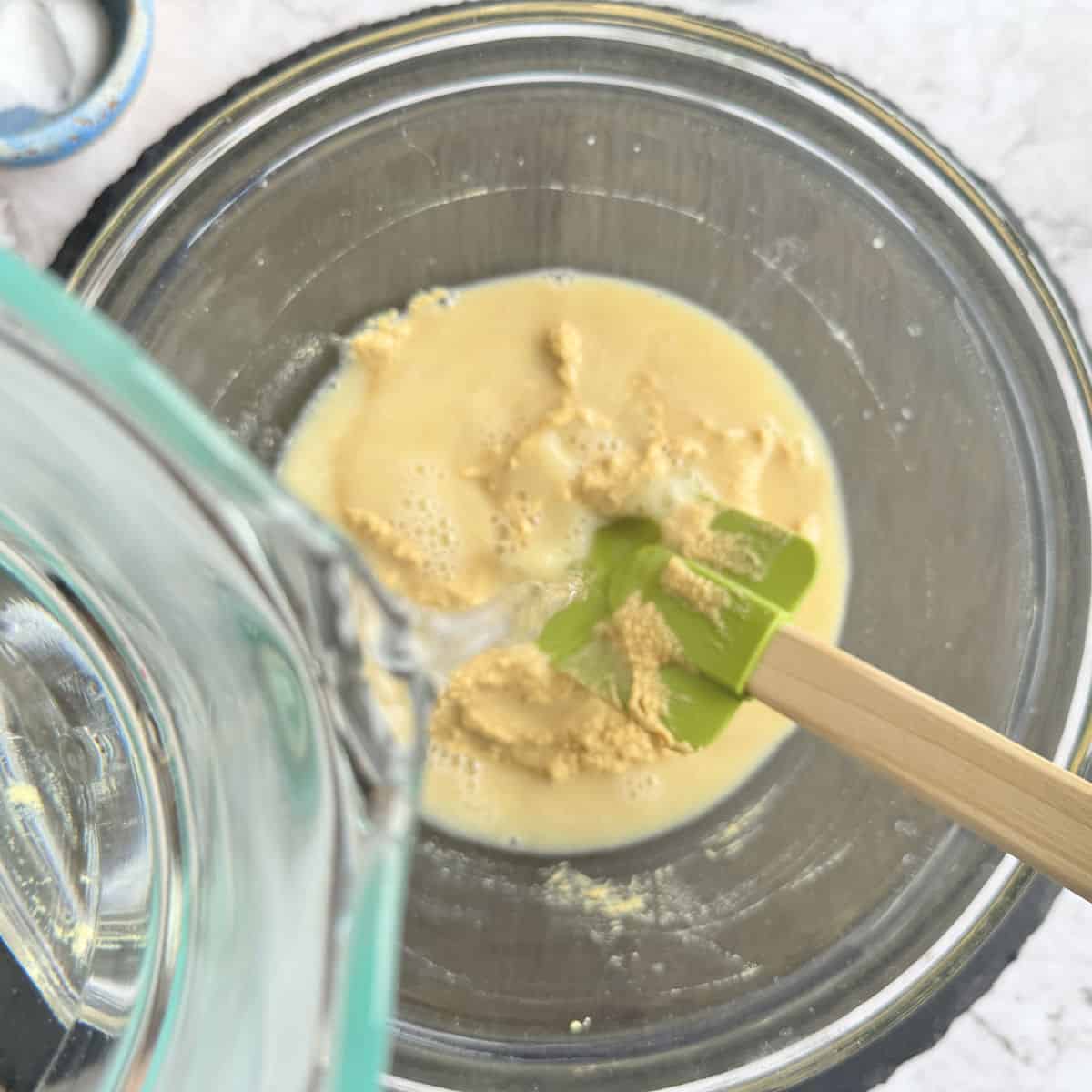 Adding water to the mustard.