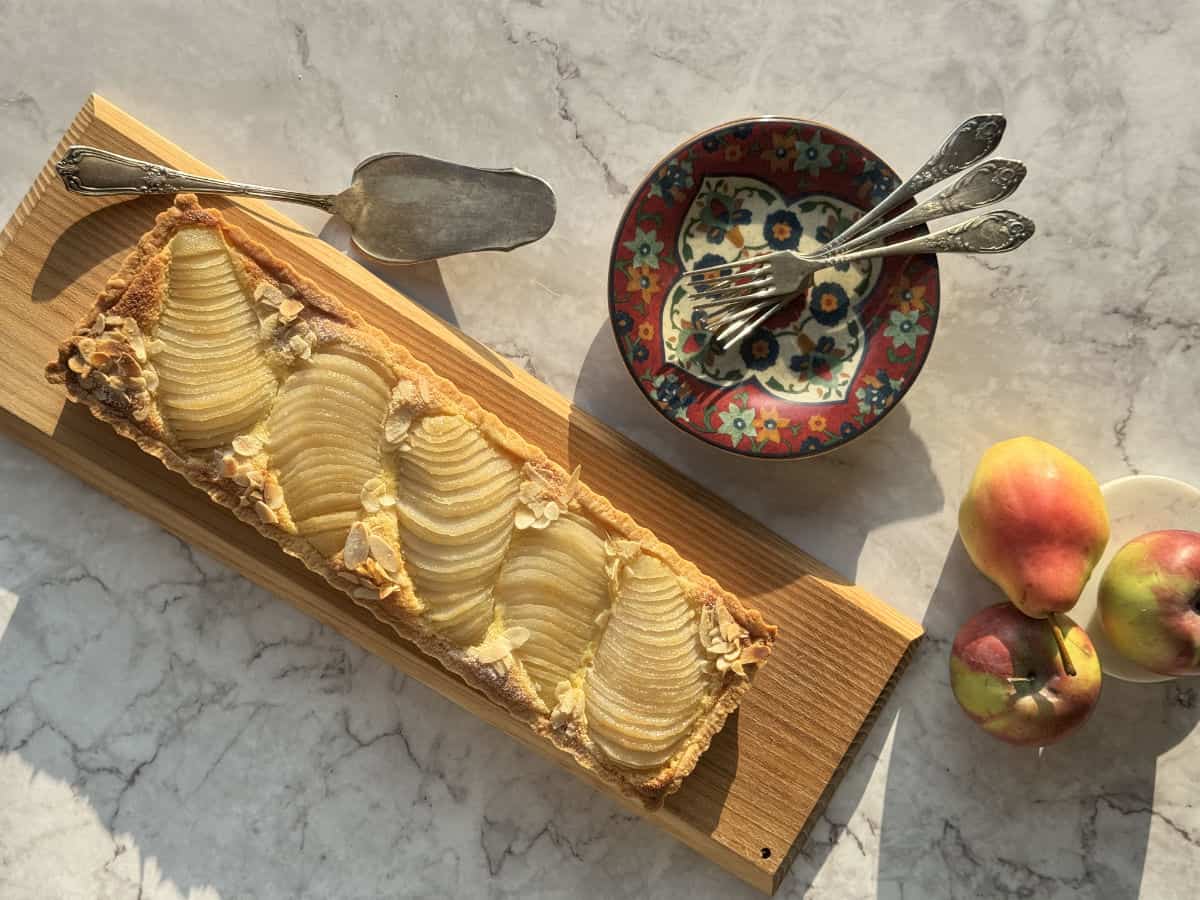 Overhead shot of the pear tart with serving plates.
