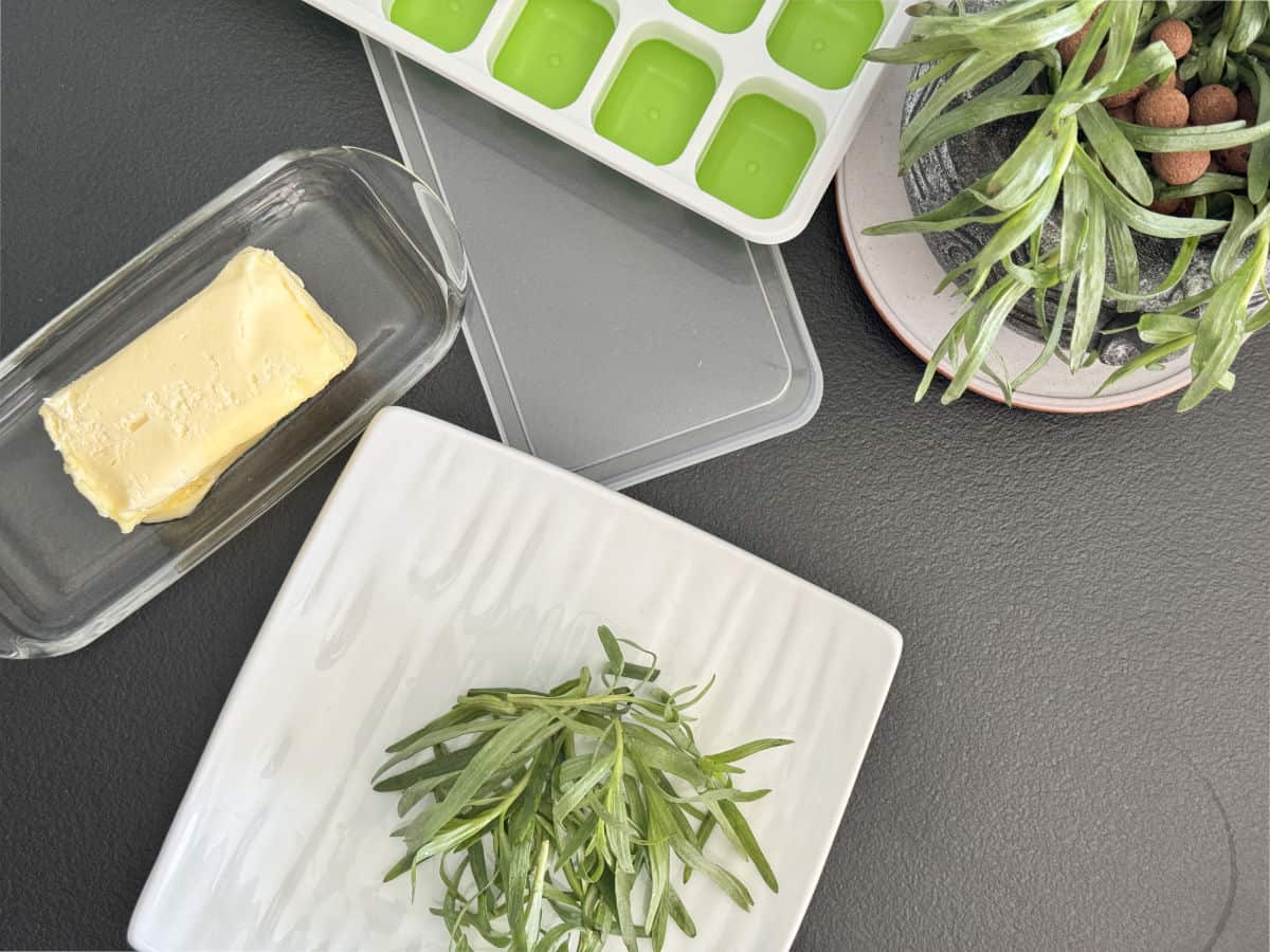 A close-up of fresh ingredients used in tarragon butter.