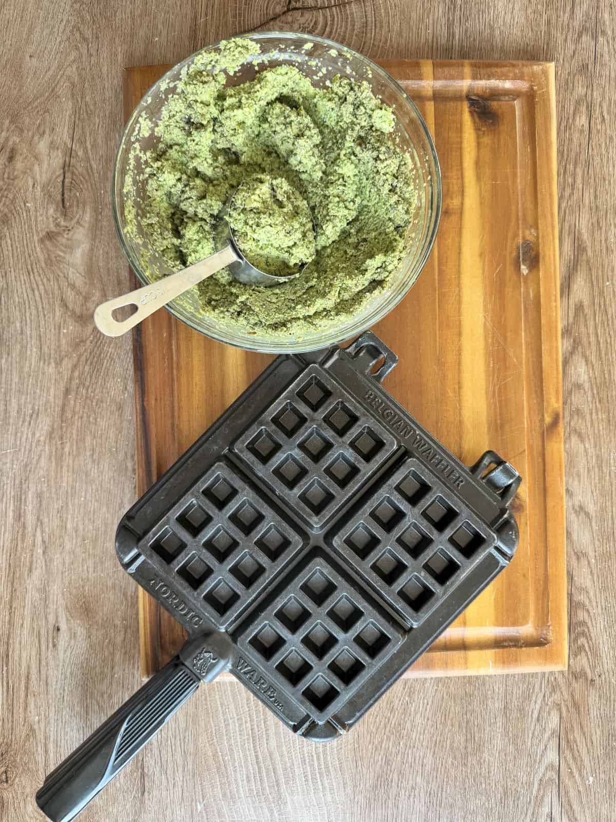 Overhead shot of a falafel dough and a waffle iron.