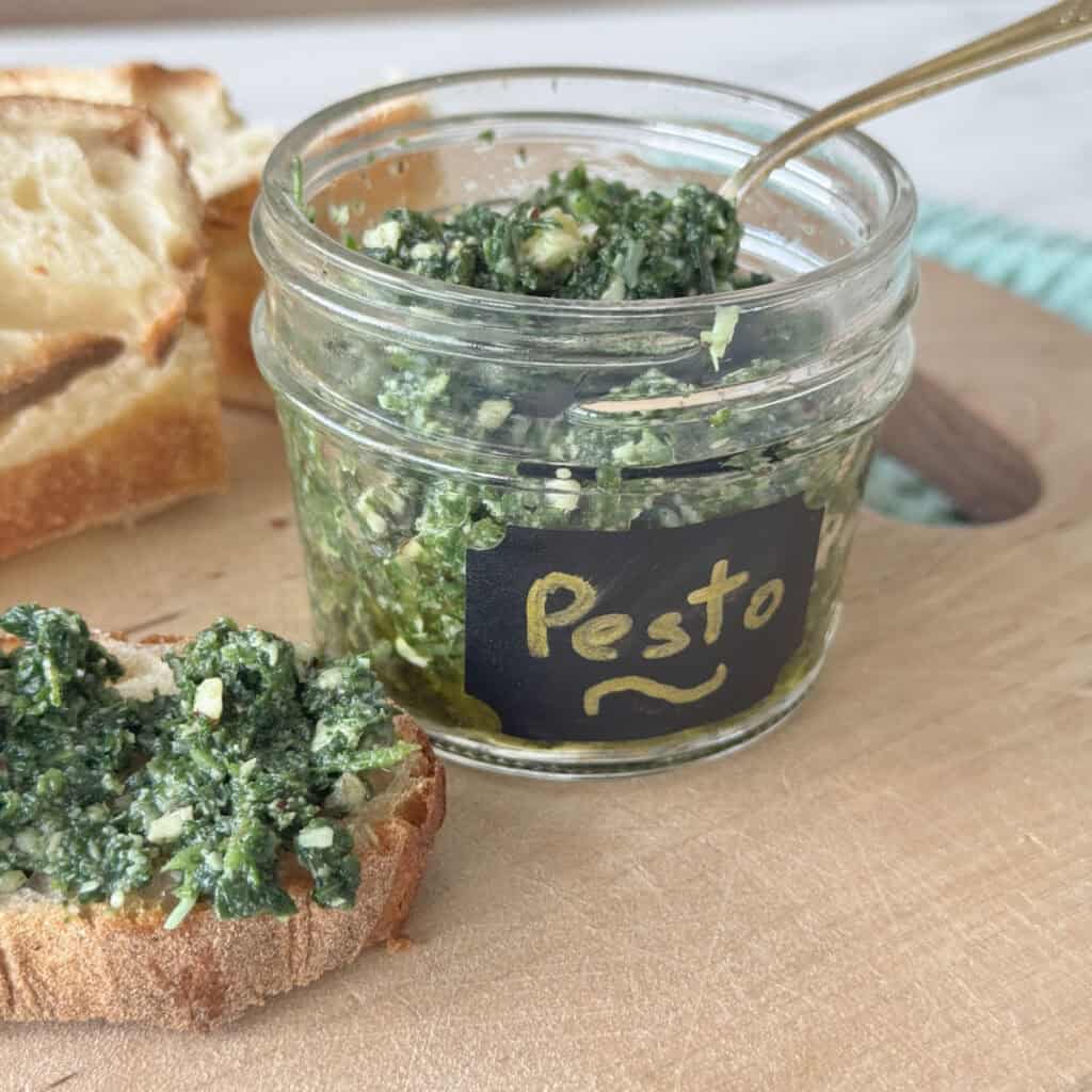 Nettle pesto spread on a bread and in the jar.