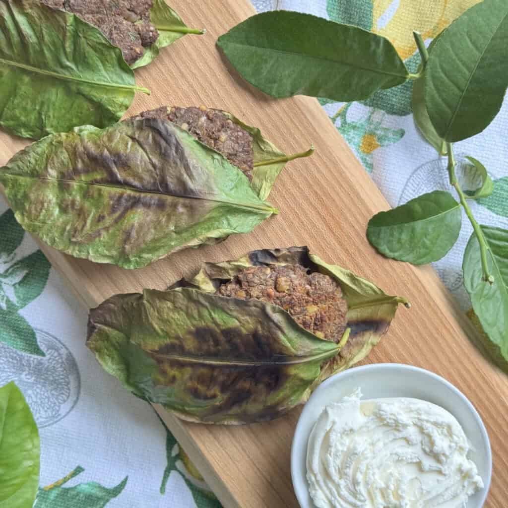 Overhead shot of lentil patties in lemon leaves.