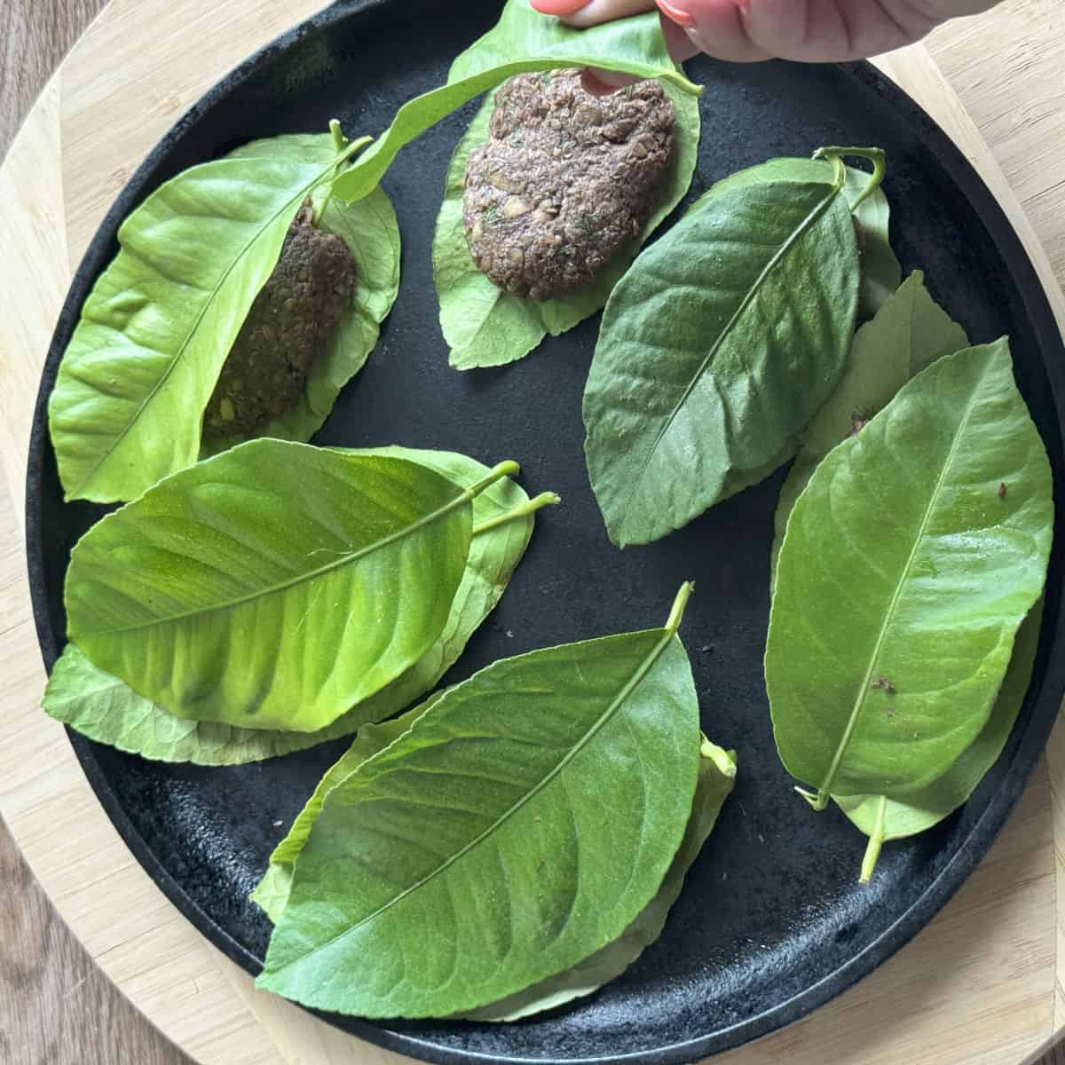 Cooking the lentil balls in a cast iron pan.
