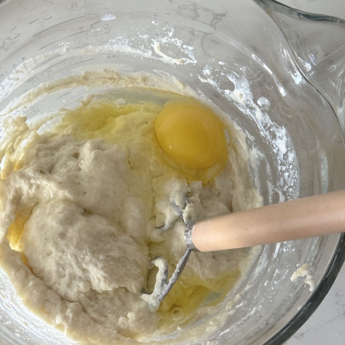 Making kefir waffle batter by adding the eggs.