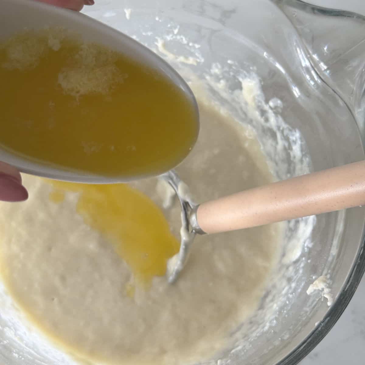 Making kefir waffle batter by adding the melted butter.