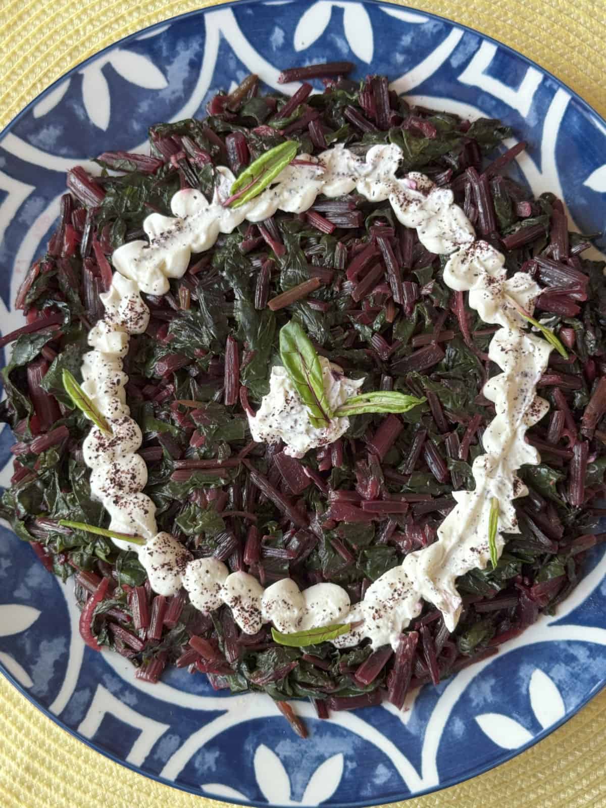 Overhead view of the sautéed beetroot greens with garlic yogurt sauce.