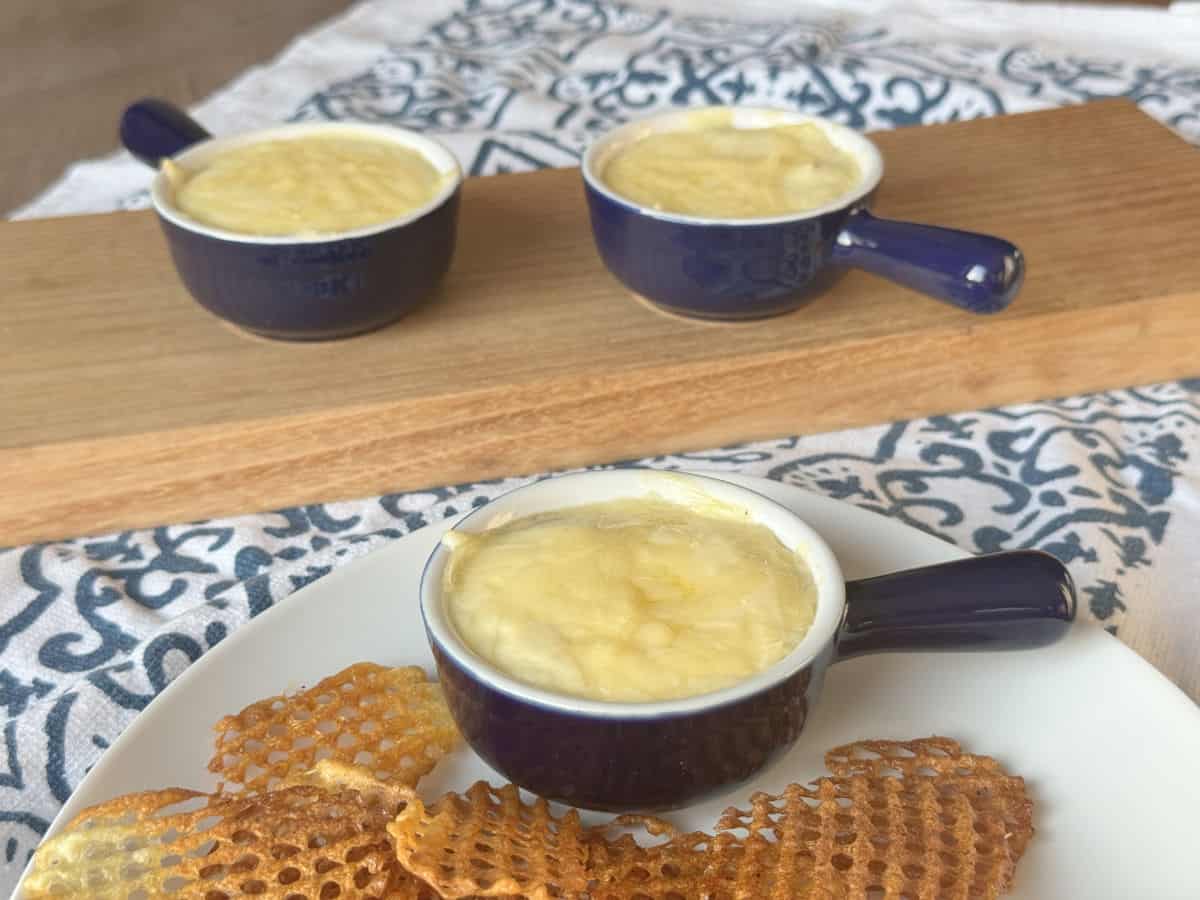 Creamy chicken julienne served in small dark blue ramekin with waffle fries.