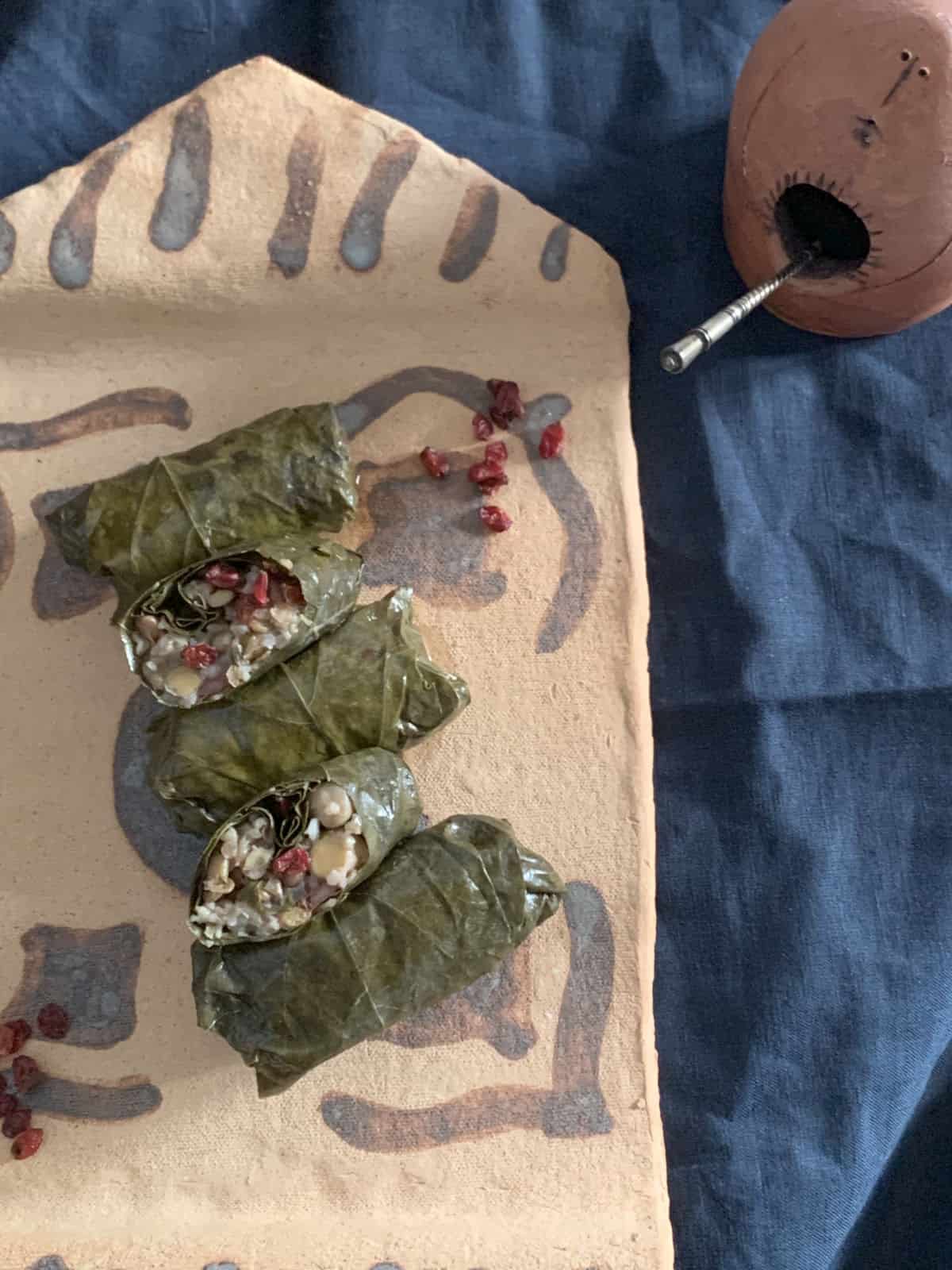 Grape leave legume tolma on a plate.