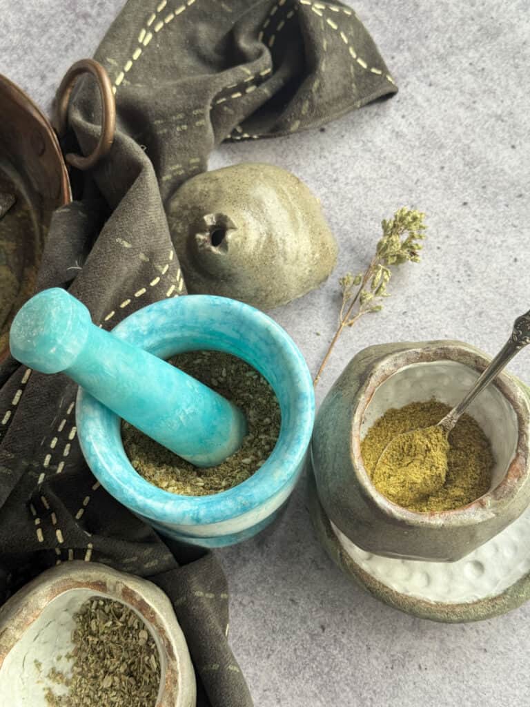 Zaatar spice blend in a jar and a mortar and pestle.