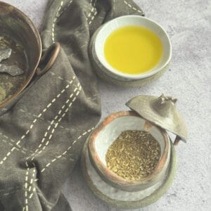 Finished homemade za'atar spice blend in a jar and dish with olive oil.