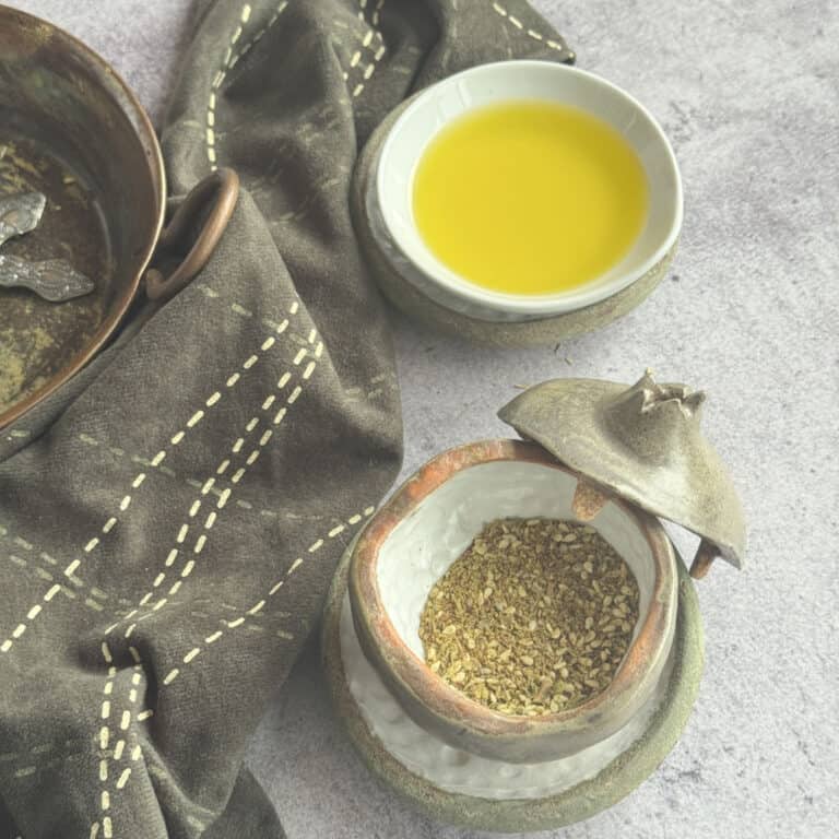 Finished homemade za'atar spice blend in a jar and dish with olive oil.