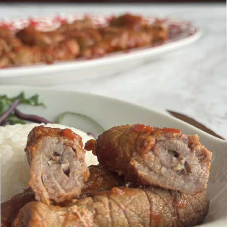 Cross cut of the Armenian Roasto and the full platter in the background.