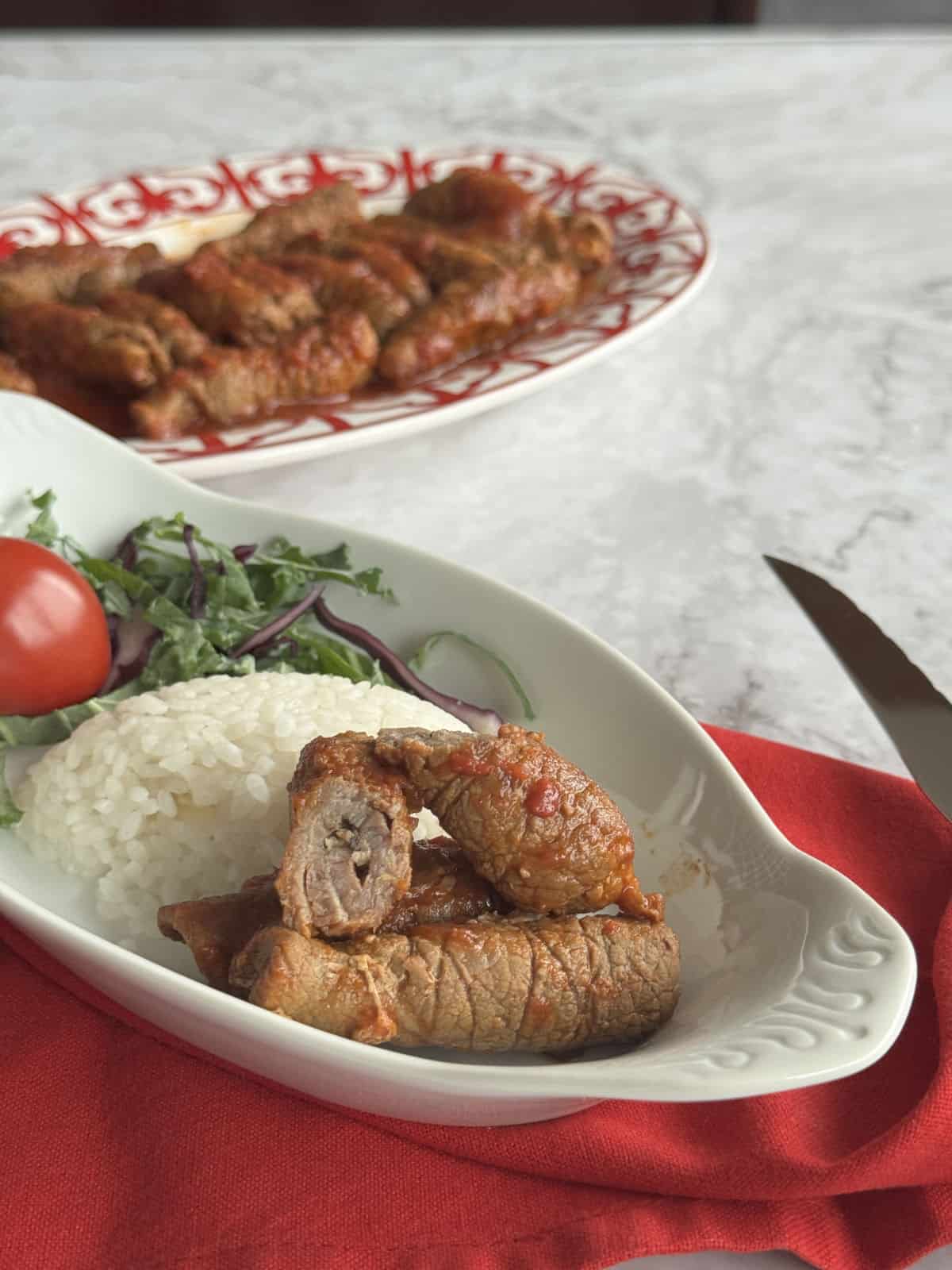 Cross cut of the Armenian Roasto and the full platter in the background.