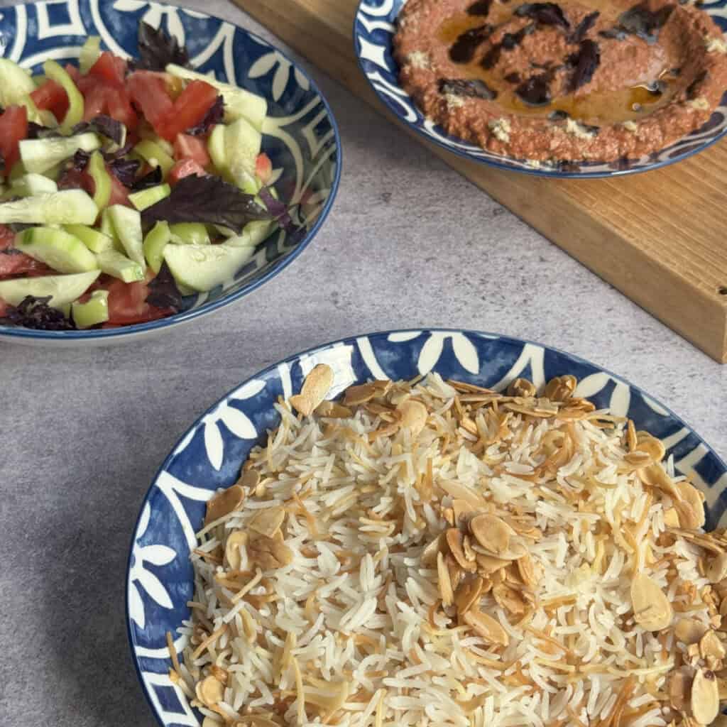 Armenian rice pilaf served with tomato summer salad and muhammara with lavash.