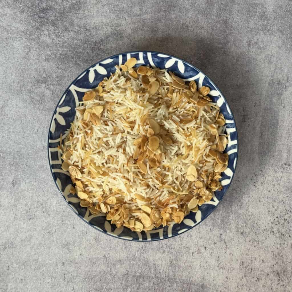 verhead view of Armenian rice pilaf with vermicelli topped with toasted almonds.