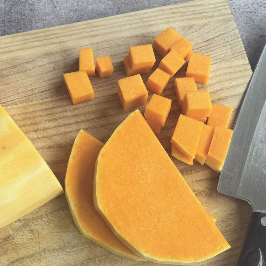 Cutting butternut squash into cubes.