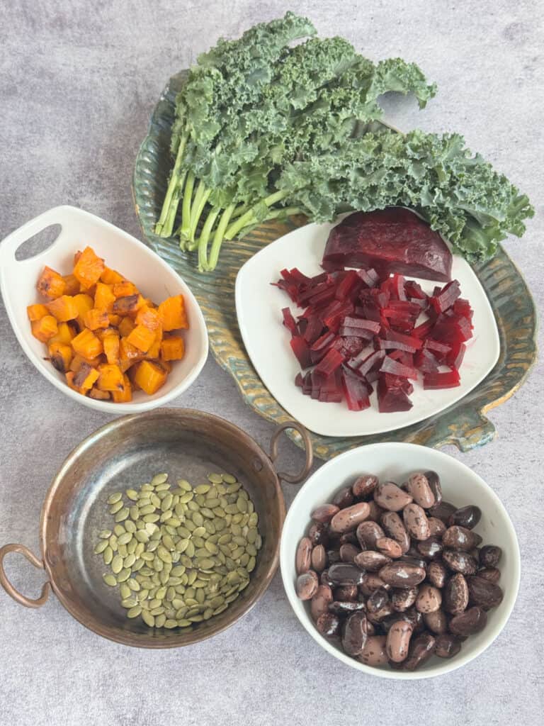 Ingredient flat lay for roasted butternut squash salad with gigante beans, beets, and kale.